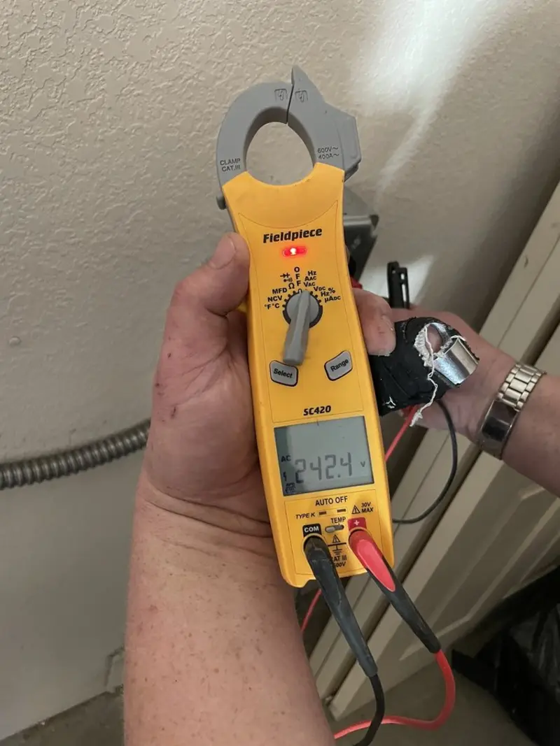 Voltage testing with clamp meter during Recessed Lighting Installation in Newtown